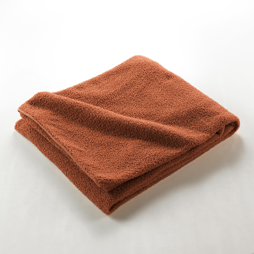 curly-woolly-throw-over-terracotta-orange-180cm-x-220cm